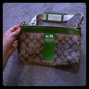 Coach purse with green detail.